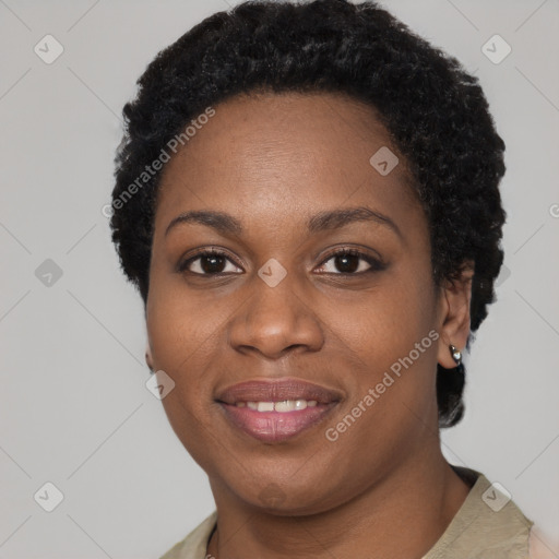 Joyful black young-adult female with short  black hair and brown eyes