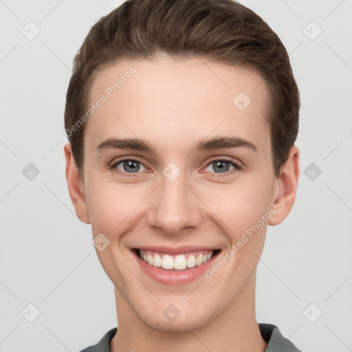 Joyful white young-adult female with short  brown hair and grey eyes