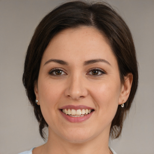 Joyful white young-adult female with medium  brown hair and brown eyes