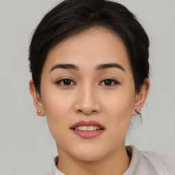 Joyful asian young-adult female with short  brown hair and brown eyes