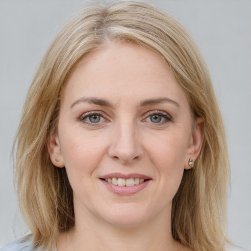 Joyful white young-adult female with medium  brown hair and blue eyes