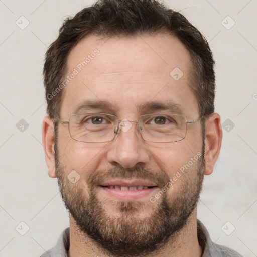 Joyful white adult male with short  brown hair and brown eyes