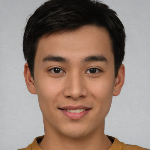 Joyful asian young-adult male with short  brown hair and brown eyes