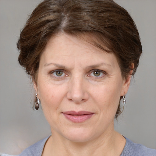 Joyful white adult female with medium  brown hair and grey eyes