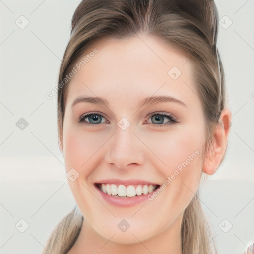 Joyful white young-adult female with long  brown hair and blue eyes