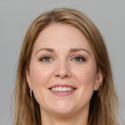 Joyful white young-adult female with long  brown hair and grey eyes