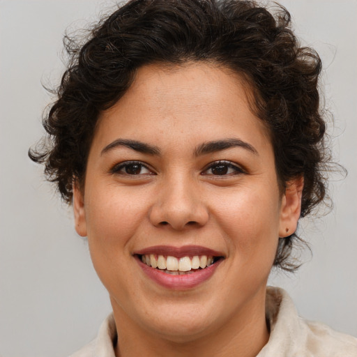 Joyful latino young-adult female with medium  brown hair and brown eyes