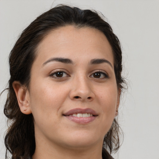 Joyful white young-adult female with medium  brown hair and brown eyes