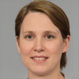 Joyful white adult female with medium  brown hair and grey eyes