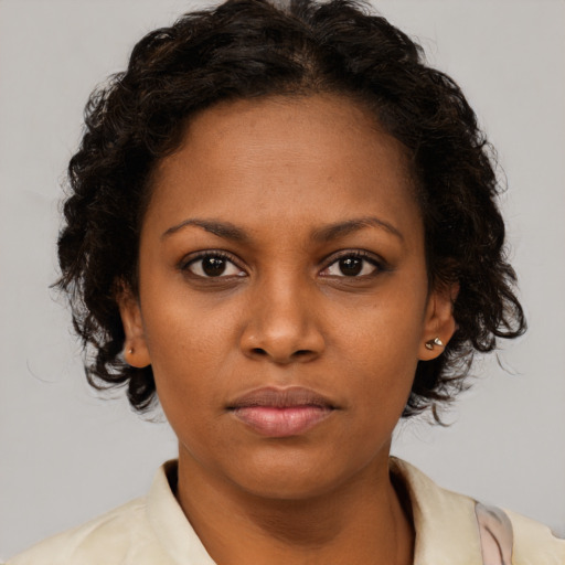 Neutral black young-adult female with medium  brown hair and brown eyes