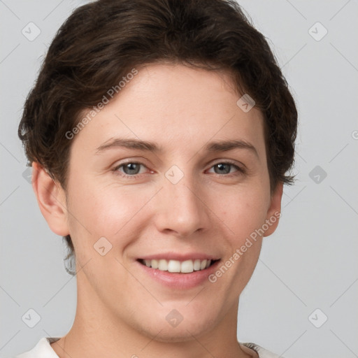 Joyful white young-adult female with short  brown hair and grey eyes