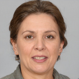 Joyful white adult female with medium  brown hair and grey eyes