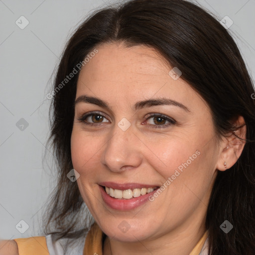 Joyful white adult female with medium  brown hair and brown eyes