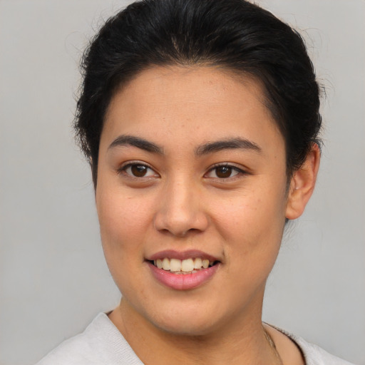 Joyful asian young-adult female with short  brown hair and brown eyes