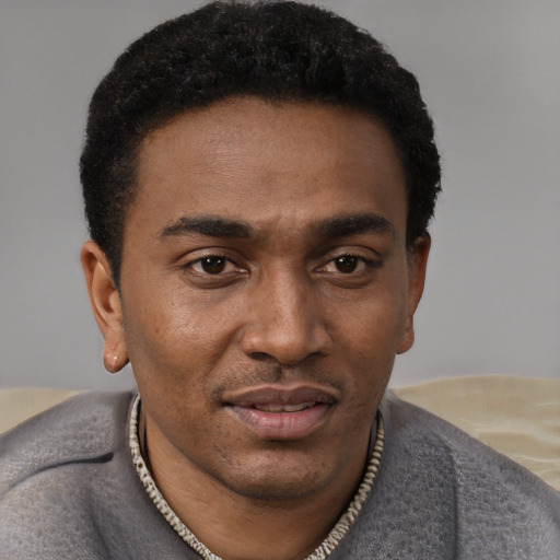 Joyful latino young-adult male with short  brown hair and brown eyes