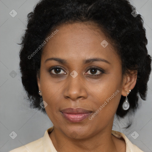 Joyful black adult female with medium  brown hair and brown eyes