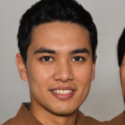 Joyful latino young-adult male with short  brown hair and brown eyes