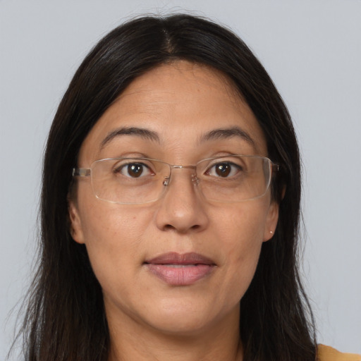 Joyful white adult female with long  brown hair and brown eyes