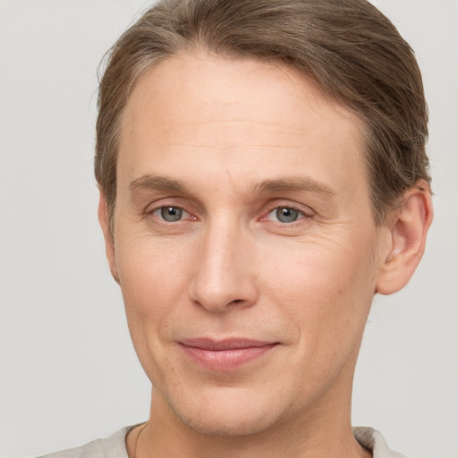 Joyful white adult male with short  brown hair and grey eyes