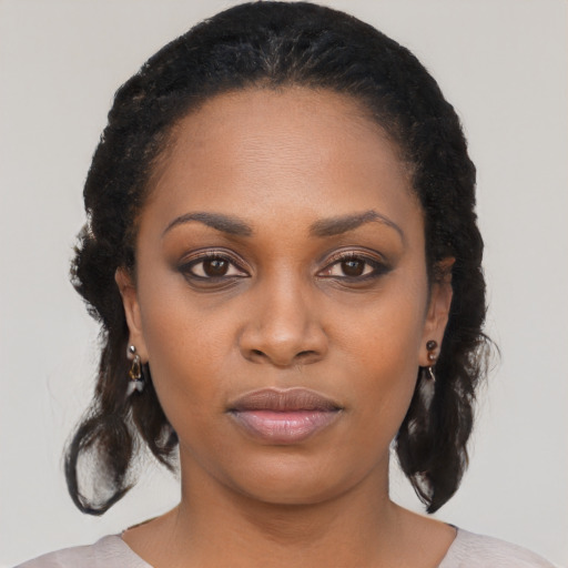 Joyful black young-adult female with medium  black hair and brown eyes