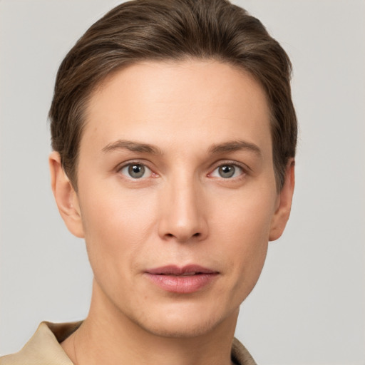 Joyful white young-adult female with short  brown hair and grey eyes