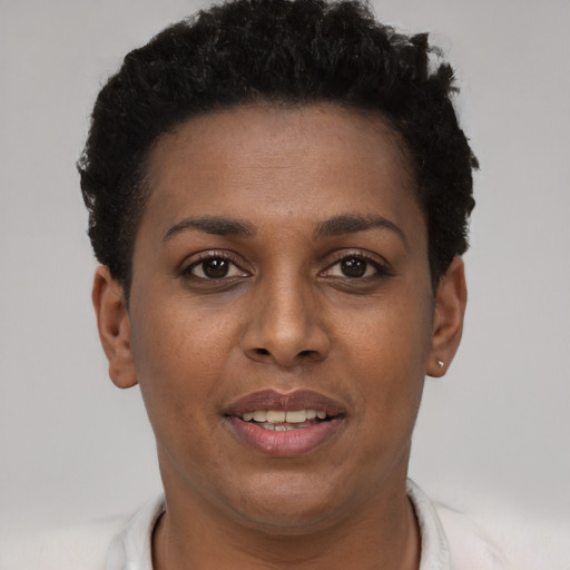 Joyful black young-adult female with short  brown hair and brown eyes