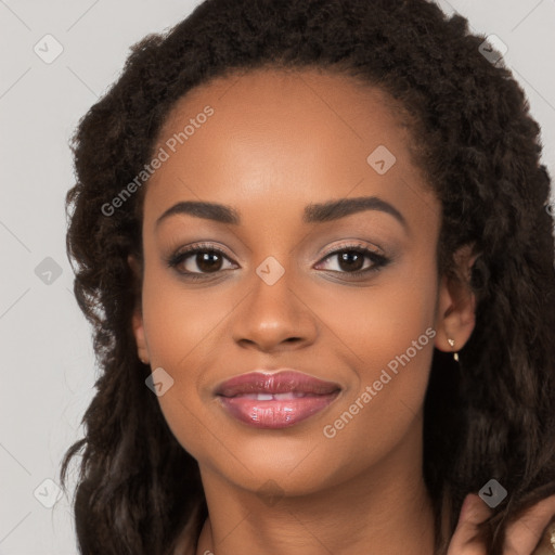 Joyful black young-adult female with long  brown hair and brown eyes