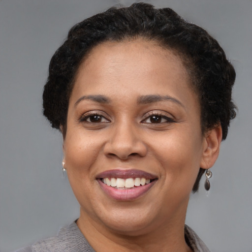 Joyful latino adult female with short  brown hair and brown eyes