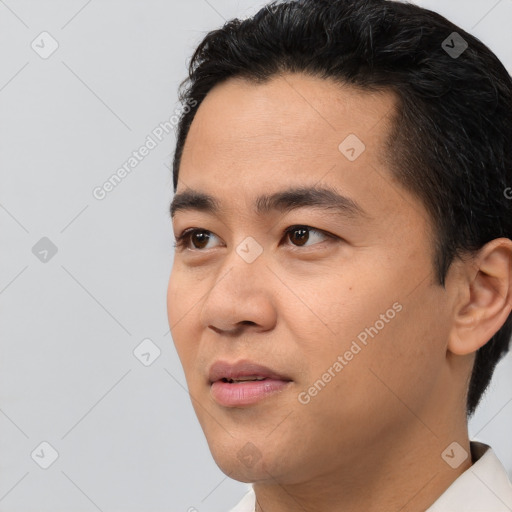 Joyful asian young-adult male with short  black hair and brown eyes