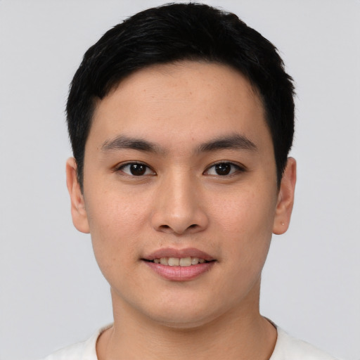 Joyful asian young-adult male with short  black hair and brown eyes