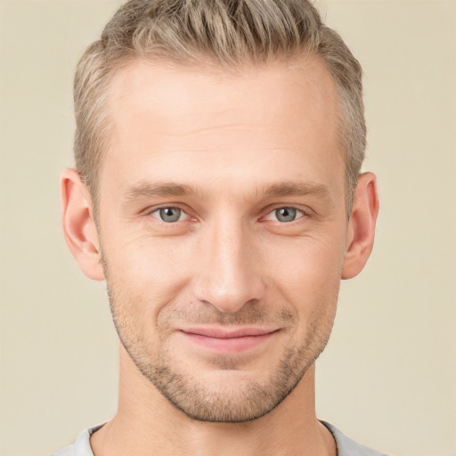 Joyful white young-adult male with short  brown hair and grey eyes