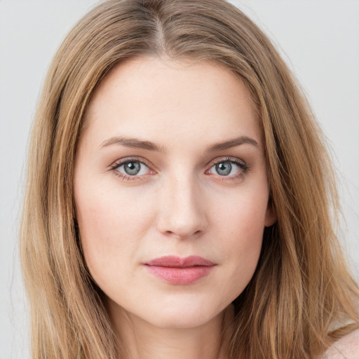 Joyful white young-adult female with long  brown hair and green eyes