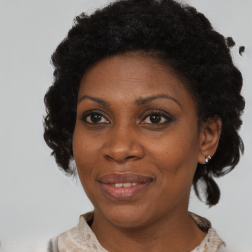 Joyful black adult female with medium  brown hair and brown eyes
