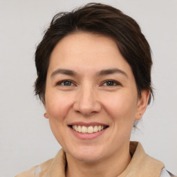 Joyful white adult female with medium  brown hair and brown eyes