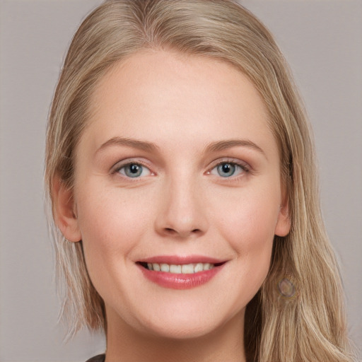 Joyful white young-adult female with long  brown hair and blue eyes