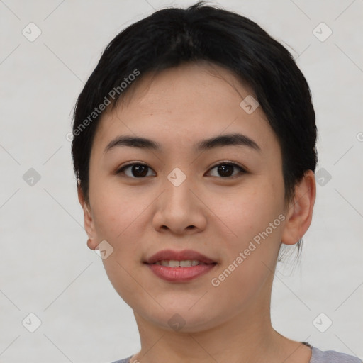 Joyful asian young-adult female with short  black hair and brown eyes