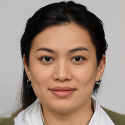 Joyful latino young-adult female with medium  brown hair and brown eyes