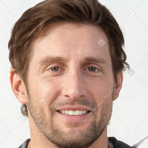 Joyful white adult male with short  brown hair and grey eyes