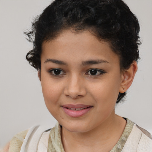 Joyful latino child female with short  brown hair and brown eyes