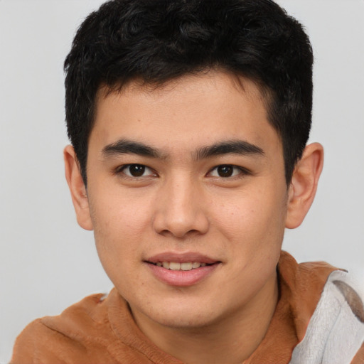 Joyful asian young-adult male with short  brown hair and brown eyes