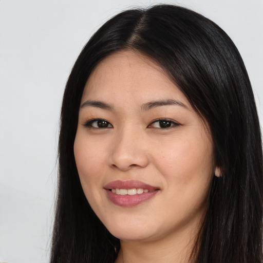 Joyful white young-adult female with long  black hair and brown eyes
