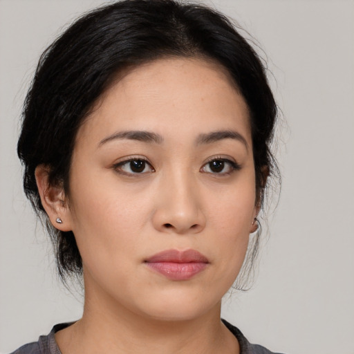 Joyful latino young-adult female with medium  black hair and brown eyes