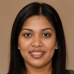 Joyful latino young-adult female with long  brown hair and brown eyes