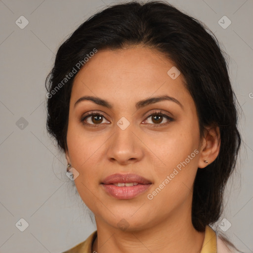 Joyful latino adult female with medium  brown hair and brown eyes