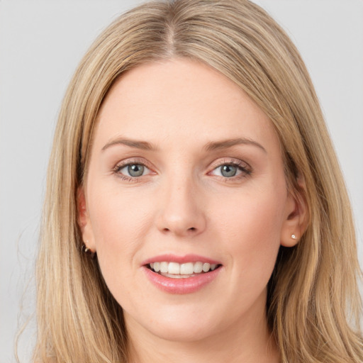 Joyful white young-adult female with long  brown hair and blue eyes