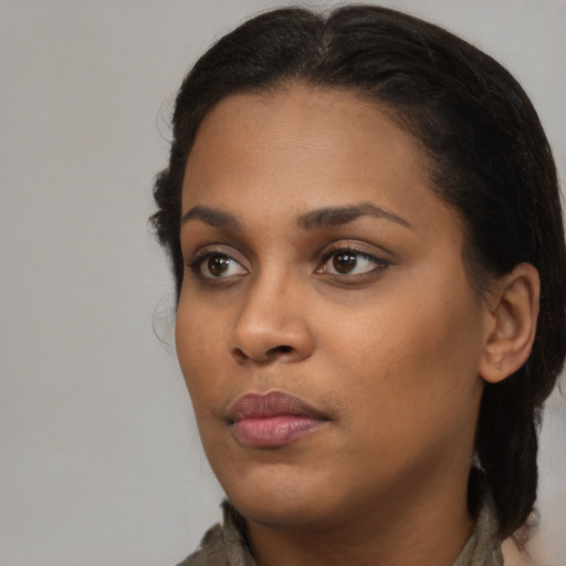 Neutral black young-adult female with medium  brown hair and brown eyes