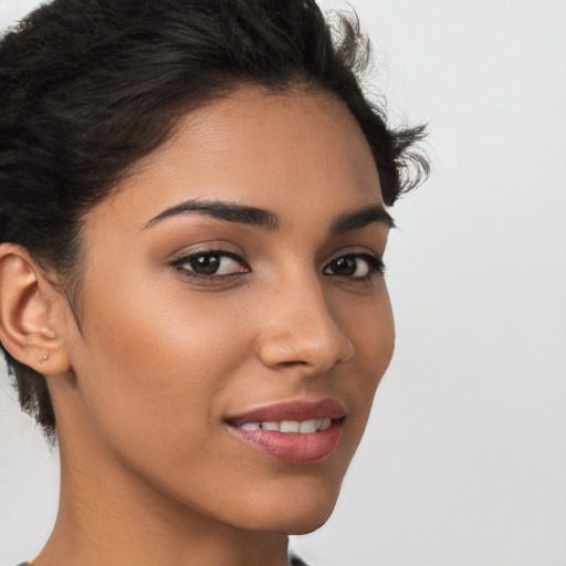 Joyful latino young-adult female with short  brown hair and brown eyes