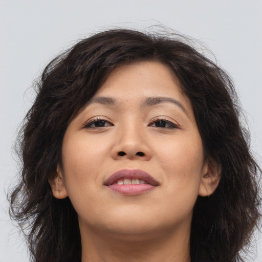 Joyful asian young-adult female with long  brown hair and brown eyes
