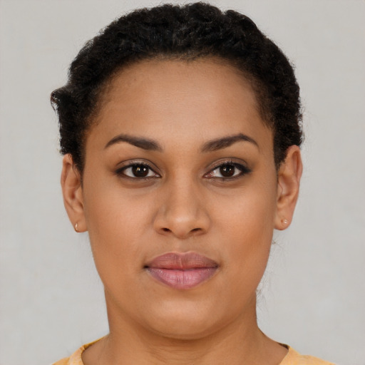 Joyful latino young-adult female with short  brown hair and brown eyes