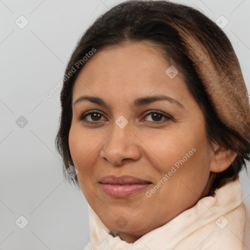 Joyful latino adult female with medium  brown hair and brown eyes